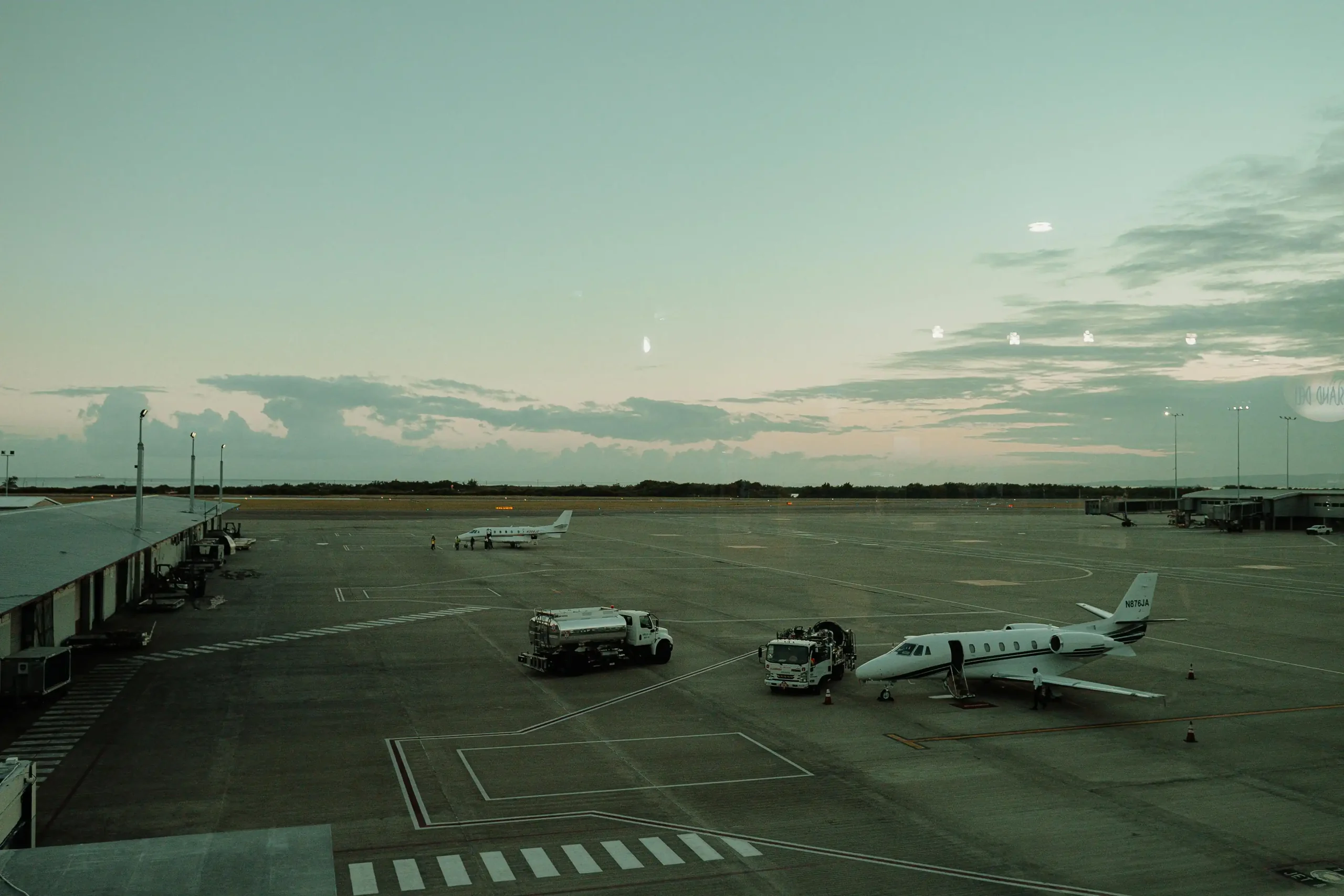Business jet parked on an airport ramp at dusk